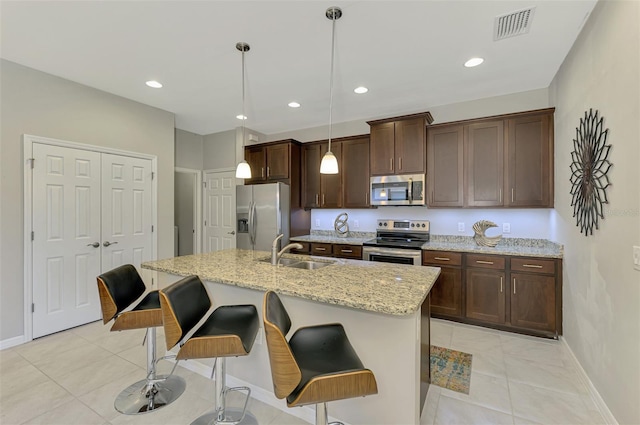20636 Swallowtail Ct, Venice, FL 34293 - kitchen with stainless steel appliances, a sink, light tile patterned flooring, baseboards, and recessed lighting