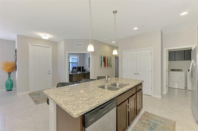 20636 Swallowtail Ct, Venice, FL 34293 - kitchen featuring stainless steel dishwasher, washer / clothes dryer, a sink, pendant lighting, and a kitchen island with sink