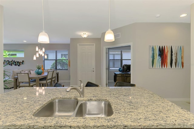 20636 Swallowtail Ct, Venice, FL 34293 - kitchen featuring a sink, baseboards, light stone counters, hanging light fixtures, and recessed lighting