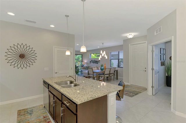 20636 Swallowtail Ct, Venice, FL 34293 - kitchen with a sink, dishwasher, dark brown cabinetry, hanging light fixtures, and baseboards