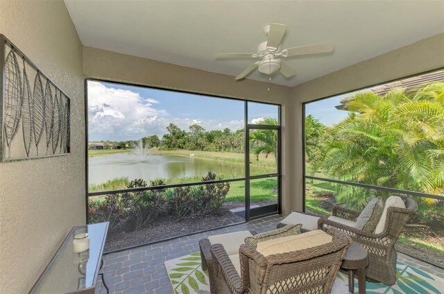 20636 Swallowtail Ct, Venice, FL 34293 - sunroom with a textured wall, a water view, ceiling fan, and tile patterned floors