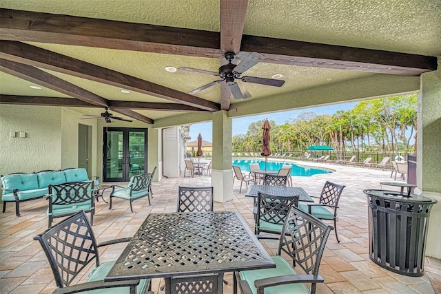 20636 Swallowtail Ct, Venice, FL 34293 - view of patio with outdoor dining space, a ceiling fan, french doors, an outdoor living space, and a community pool