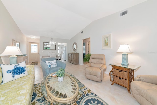 6796 Gasparilla Pines Blvd Unit 18, Englewood, FL 34224 - living area featuring light tile patterned floors, lofted ceiling, a chandelier, and baseboards