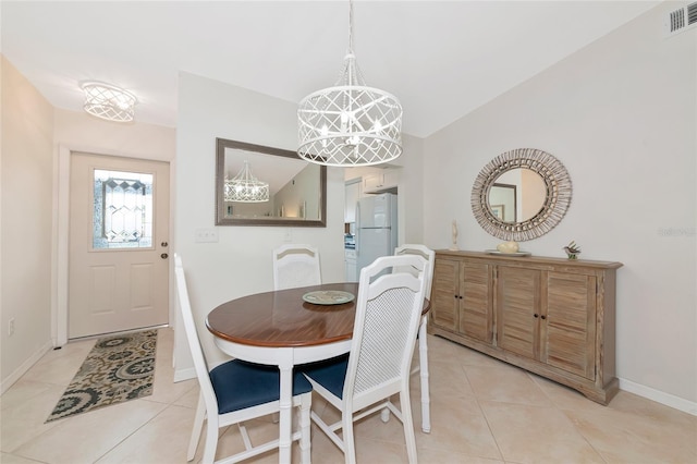 6796 Gasparilla Pines Blvd Unit 18, Englewood, FL 34224 - dining room featuring a chandelier, light tile patterned floors, and baseboards
