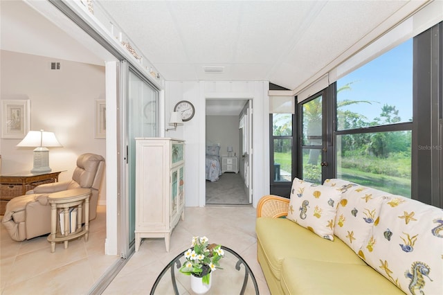 6796 Gasparilla Pines Blvd Unit 18, Englewood, FL 34224 - living area featuring vaulted ceiling and light tile patterned flooring