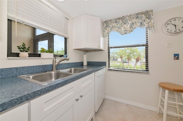 6796 Gasparilla Pines Blvd Unit 18, Englewood, FL 34224 - kitchen with a sink, white cabinetry, dark countertops, white dishwasher, and baseboards
