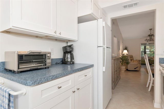 6796 Gasparilla Pines Blvd Unit 18, Englewood, FL 34224 - kitchen with ceiling fan, white cabinetry, light tile patterned floors, and dark countertops