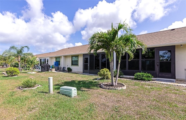 6796 Gasparilla Pines Blvd Unit 18, Englewood, FL 34224 - rear view of house with central air condition unit, a yard, and stucco siding