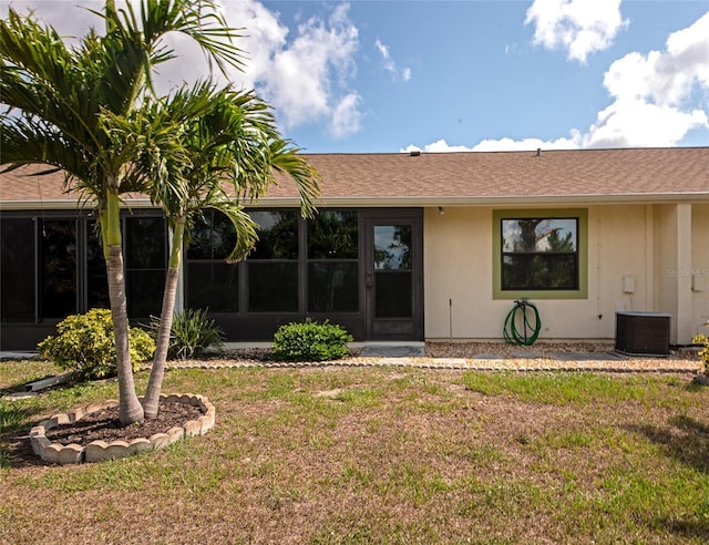 6796 Gasparilla Pines Blvd Unit 18, Englewood, FL 34224 - rear view of house featuring a yard, cooling unit, and a shingled roof