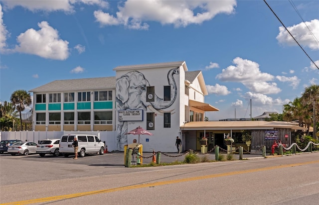 6796 Gasparilla Pines Blvd Unit 18, Englewood, FL 34224 - view of building exterior with uncovered parking and fence