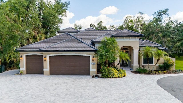 5850 Saddle Oak Trl, Sarasota, FL 34241 - view of front facade featuring a garage, stucco siding, and decorative driveway