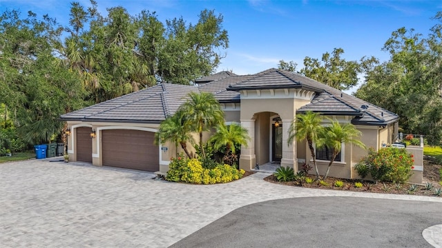 5850 Saddle Oak Trl, Sarasota, FL 34241 - view of front of house with stucco siding, decorative driveway, an attached garage, and a tile roof
