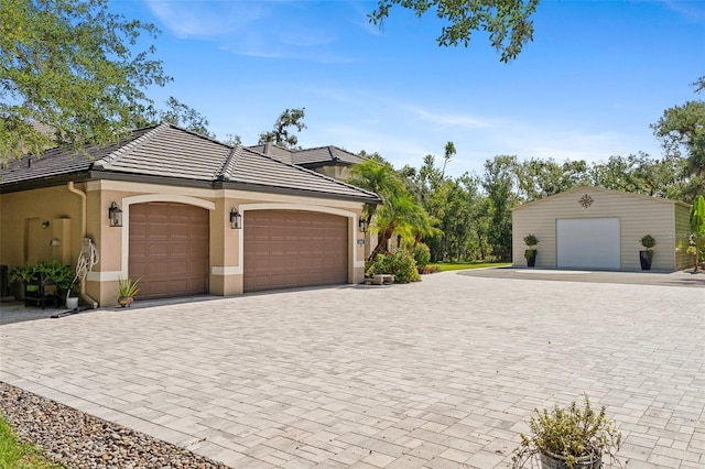 5850 Saddle Oak Trl, Sarasota, FL 34241 - view of front of house with stucco siding, a tiled roof, an attached garage, and driveway