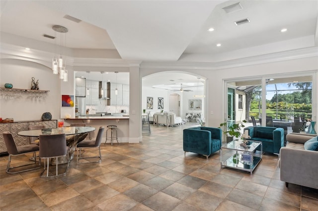 5850 Saddle Oak Trl, Sarasota, FL 34241 - dining room featuring a raised ceiling, ceiling fan, crown molding, arched walkways, and recessed lighting
