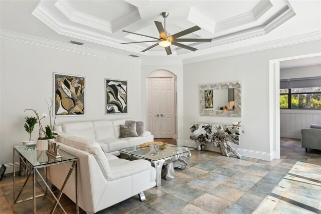5850 Saddle Oak Trl, Sarasota, FL 34241 - living area featuring coffered ceiling, ornamental molding, ceiling fan, baseboards, and arched walkways