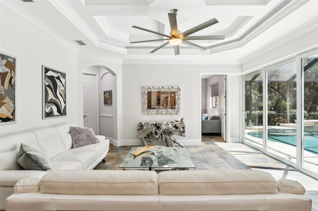 5850 Saddle Oak Trl, Sarasota, FL 34241 - living room featuring arched walkways, ceiling fan, crown molding, a raised ceiling, and baseboards