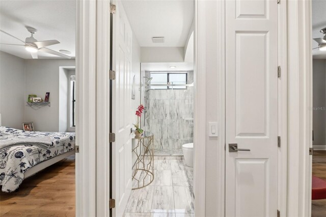 5850 Saddle Oak Trl, Sarasota, FL 34241 - ensuite bathroom with a shower stall, a ceiling fan, and toilet