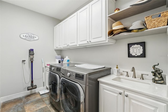 5850 Saddle Oak Trl, Sarasota, FL 34241 - washroom featuring cabinet space, washer and clothes dryer, baseboards, and stone finish floors