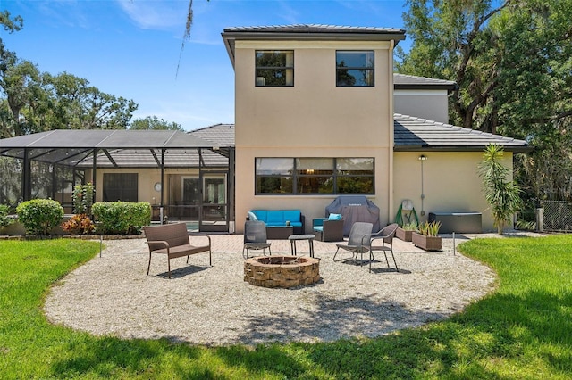 5850 Saddle Oak Trl, Sarasota, FL 34241 - back of property featuring an outdoor living space with a fire pit, a patio, stucco siding, and a lawn