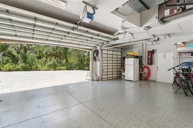 5850 Saddle Oak Trl, Sarasota, FL 34241 - garage featuring freestanding refrigerator and a garage door opener