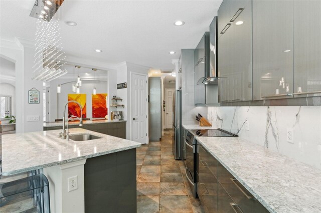 5850 Saddle Oak Trl, Sarasota, FL 34241 - kitchen with appliances with stainless steel finishes, a sink, wall chimney exhaust hood, light stone counters, and modern cabinets