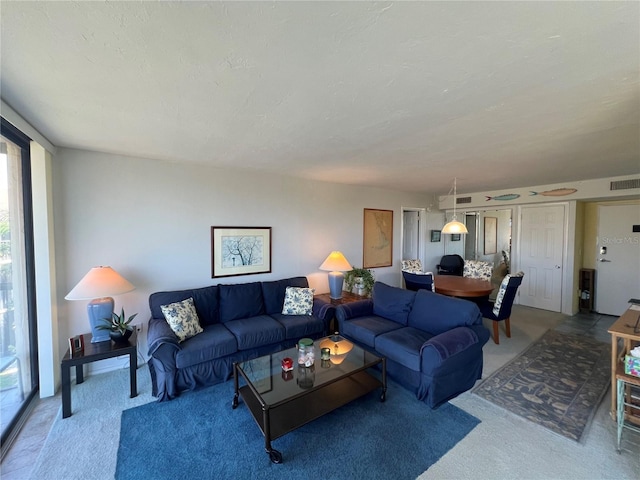 612 Bird Bay Dr S Unit 308, Venice, FL 34285 - living area with healthy amount of natural light and carpet flooring