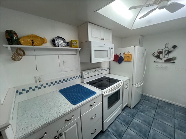 612 Bird Bay Dr S Unit 308, Venice, FL 34285 - kitchen featuring white appliances, open shelves, dark tile patterned floors, white cabinetry, and a ceiling fan