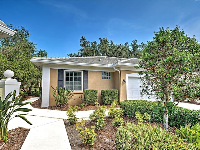 912 Barclay Ct, Venice, FL 34293 - view of front of property with stucco siding, an attached garage, and a tile roof