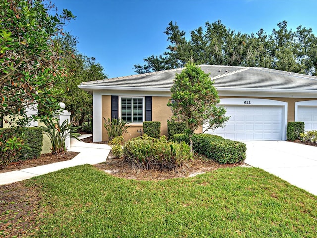 912 Barclay Ct, Venice, FL 34293 - view of front of home featuring a garage, concrete driveway, a tiled roof, stucco siding, and a front yard