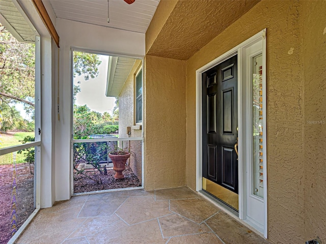 912 Barclay Ct, Venice, FL 34293 - property entrance featuring stucco siding and a ceiling fan