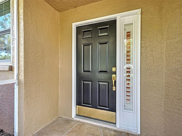 912 Barclay Ct, Venice, FL 34293 - doorway to property featuring stucco siding