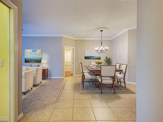 912 Barclay Ct, Venice, FL 34293 - dining room featuring a chandelier, ornamental molding, light tile patterned floors, and baseboards