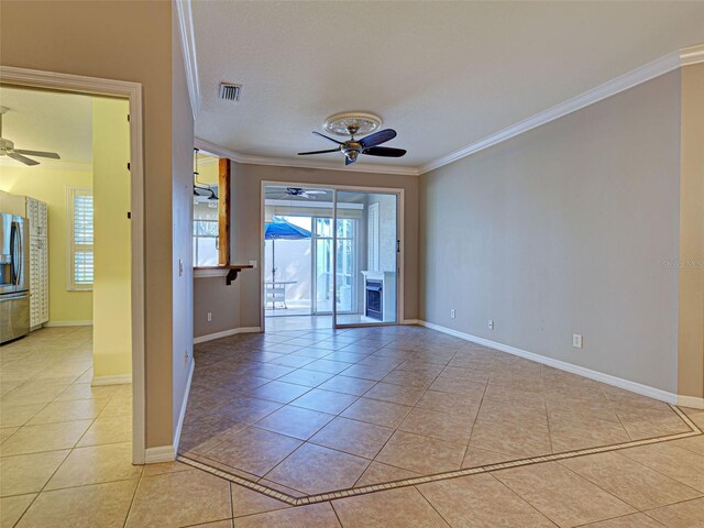 912 Barclay Ct, Venice, FL 34293 - spare room with ceiling fan, ornamental molding, light tile patterned floors, and baseboards