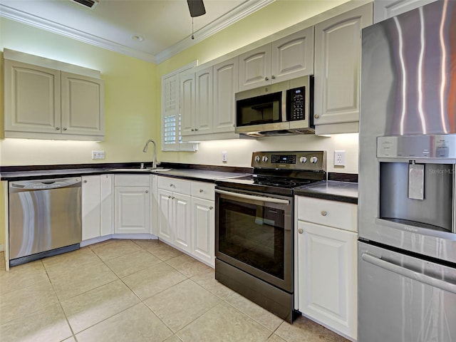 912 Barclay Ct, Venice, FL 34293 - kitchen with appliances with stainless steel finishes, dark countertops, ornamental molding, light tile patterned flooring, and a sink
