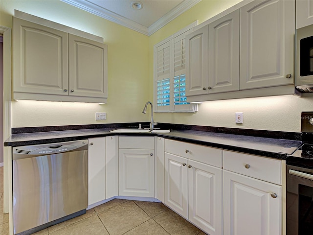 912 Barclay Ct, Venice, FL 34293 - kitchen with appliances with stainless steel finishes, a sink, ornamental molding, dark countertops, and white cabinetry