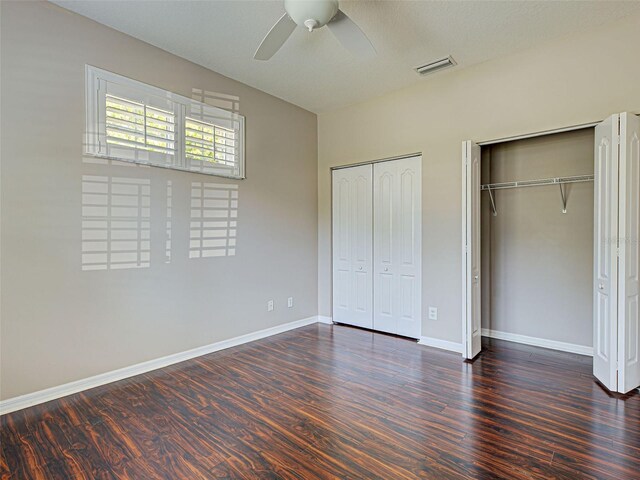912 Barclay Ct, Venice, FL 34293 - unfurnished bedroom featuring two closets, wood finished floors, and baseboards