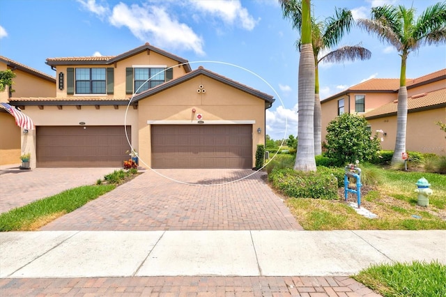 10808 Tarflower Dr Unit 102, Venice, FL 34293 - view of front of house with stucco siding, decorative driveway, and an attached garage