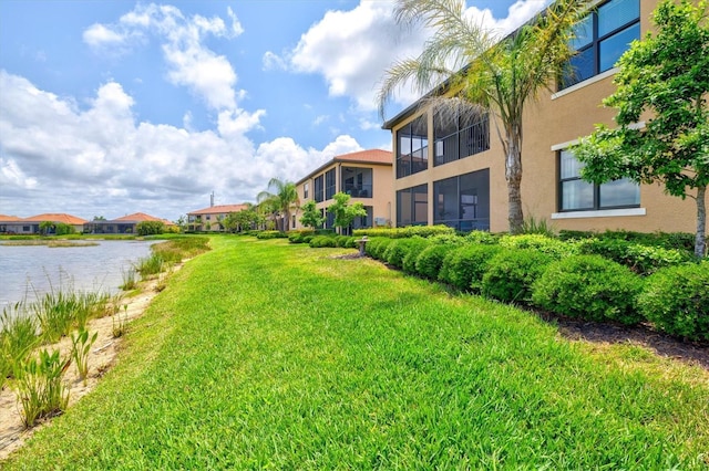 10808 Tarflower Dr Unit 102, Venice, FL 34293 - view of grassy yard with a residential view and a water view