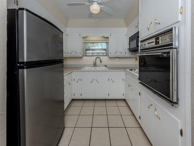 4192 Tarpon Rd, Venice, FL 34293 - kitchen with black appliances, a sink, light tile patterned floors, white cabinetry, and light countertops