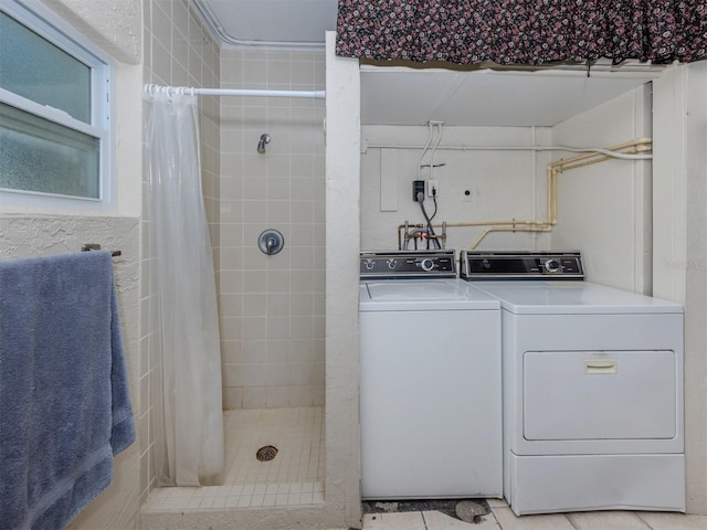 4192 Tarpon Rd, Venice, FL 34293 - bathroom featuring washer and dryer, a stall shower, and tile patterned flooring