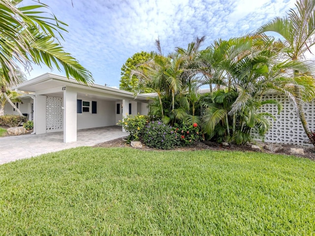 832 Whitecap Cir Unit 5, Venice, FL 34285 - view of green lawn with an attached carport