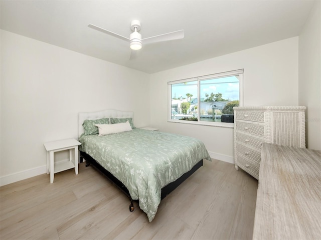 832 Whitecap Cir Unit 5, Venice, FL 34285 - bedroom with baseboards, light wood-type flooring, and ceiling fan
