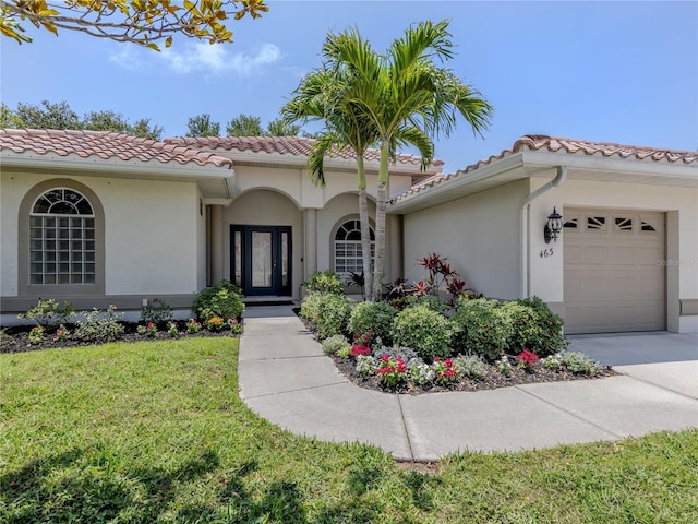 463 Park Trace Blvd, Osprey, FL 34229 - mediterranean / spanish house with a tile roof, stucco siding, and a front lawn