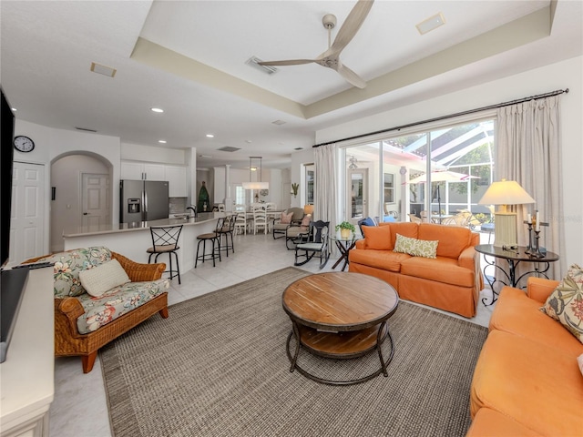 463 Park Trace Blvd, Osprey, FL 34229 - living room with a ceiling fan, a tray ceiling, recessed lighting, and light tile patterned flooring