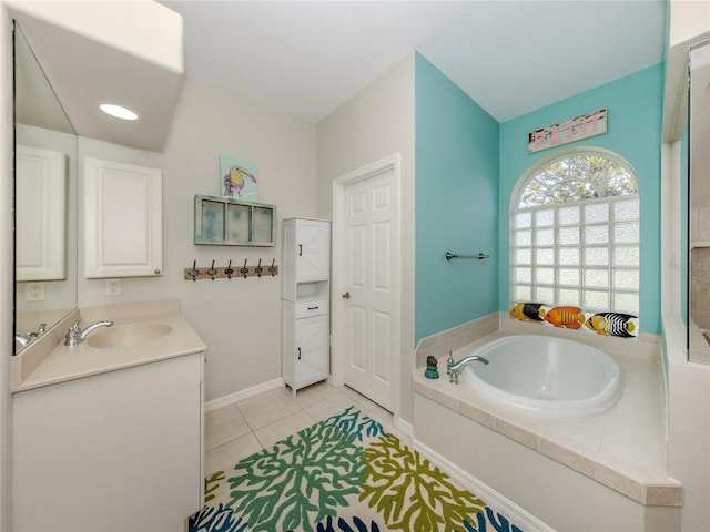 463 Park Trace Blvd, Osprey, FL 34229 - full bathroom with tile patterned flooring, a garden tub, vanity, and baseboards