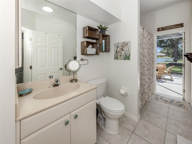 463 Park Trace Blvd, Osprey, FL 34229 - bathroom featuring toilet, vanity, tile patterned floors, baseboards, and curtained shower