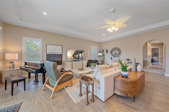 9220 43rd Ter W, Bradenton, FL 34209 - living area featuring a raised ceiling, arched walkways, ceiling fan, ornamental molding, and recessed lighting