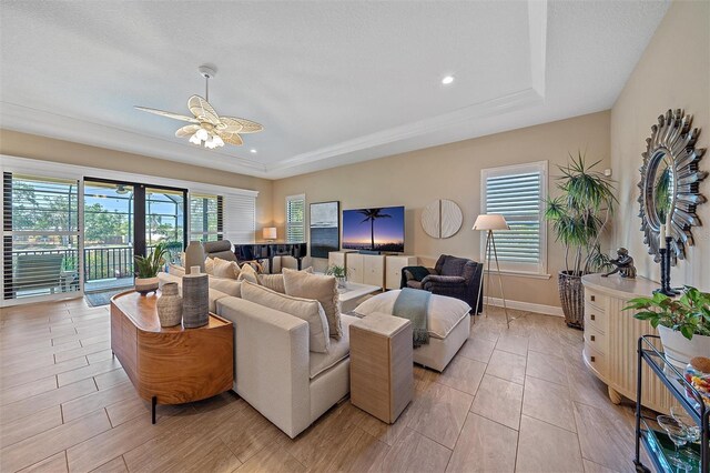 9220 43rd Ter W, Bradenton, FL 34209 - living room with a raised ceiling, ceiling fan, baseboards, and recessed lighting