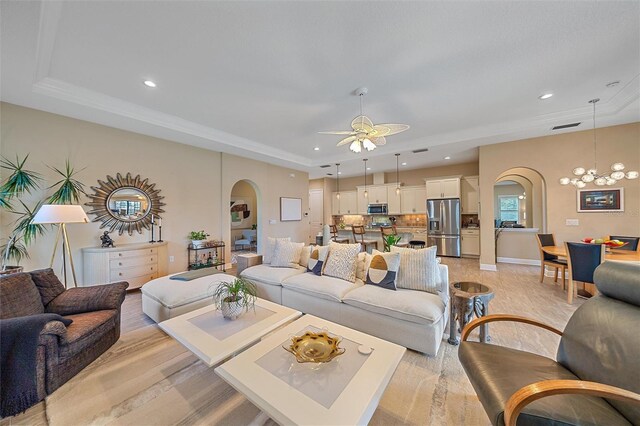 9220 43rd Ter W, Bradenton, FL 34209 - living area featuring arched walkways, recessed lighting, a ceiling fan, a tray ceiling, and light wood-style flooring