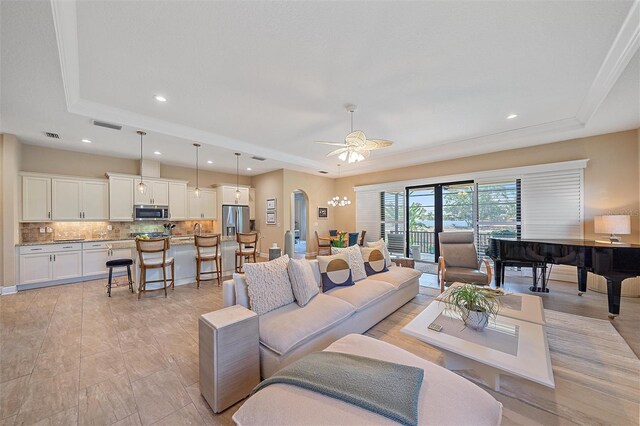 9220 43rd Ter W, Bradenton, FL 34209 - living area featuring a tray ceiling, ceiling fan, arched walkways, and recessed lighting